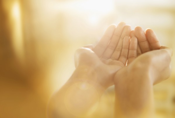 Mixed race woman holding out cupped hands
