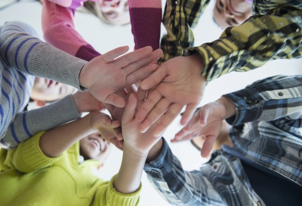Children cheering in huddle