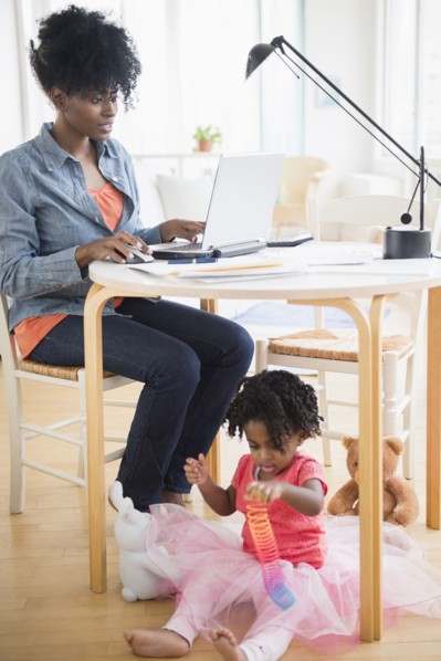 Mother and daughter relaxing in living room
