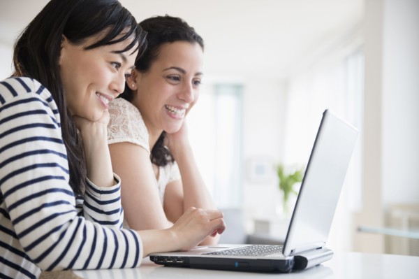 Women using laptop together
