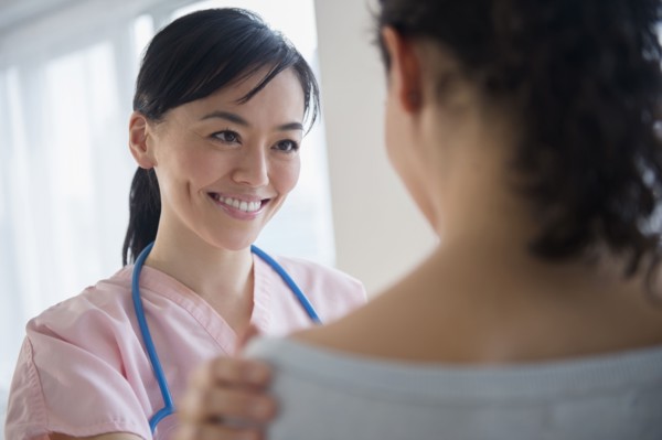 Nurse talking to patient in hospital