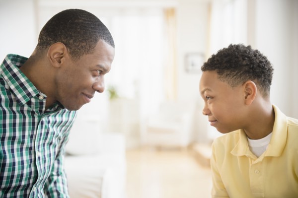 Father and son making faces at each other