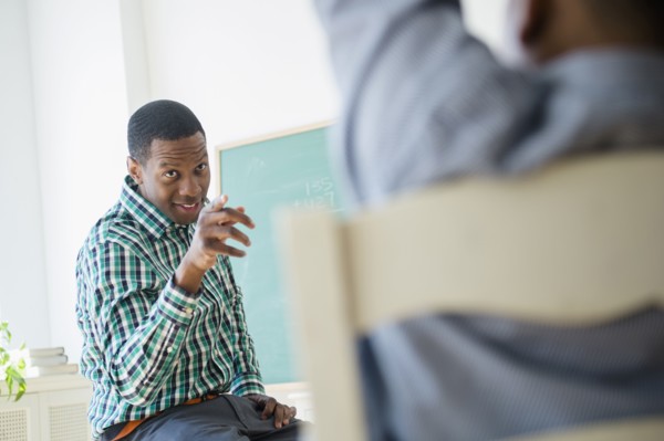Teacher pointing at student in classroom