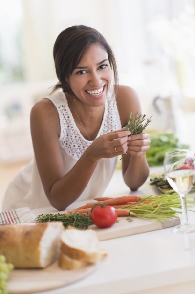 Hispanic woman cooking in kitchen