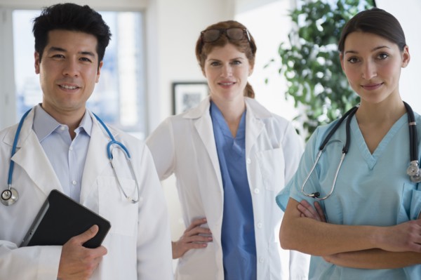 Doctors and nurse smiling in office