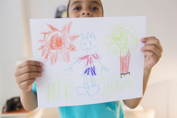 Mixed race boy displaying drawing