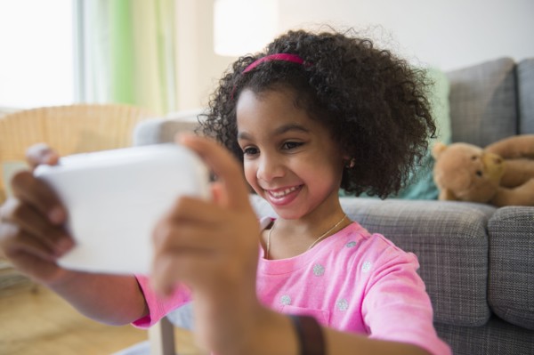 African American girl taking pictures with cell phone