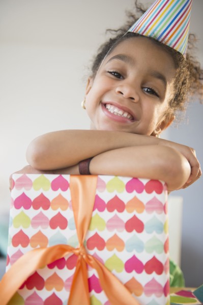 African American girl holding wrapped birthday gift