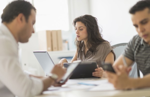 Hispanic business people using technology in office
