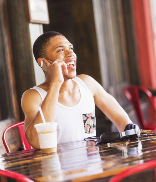 African American man talking on cell phone at cafe