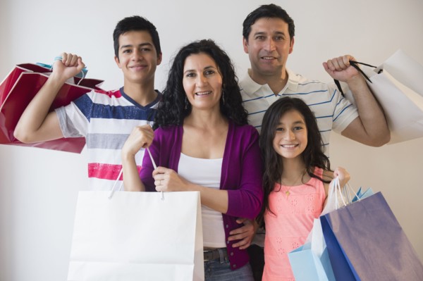 Hispanic family holding shopping bags together