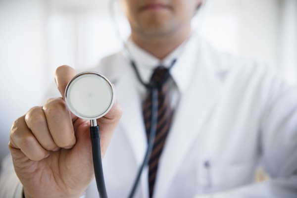 Close up of mixed race doctor holding stethoscope