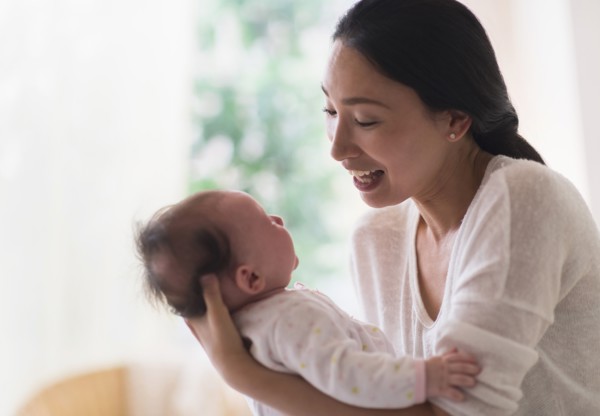 Asian mother holding baby
