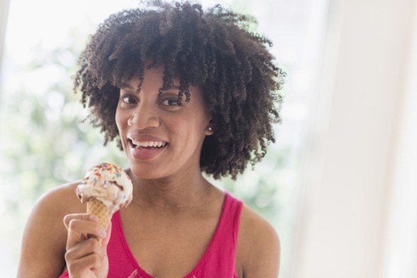 African American woman eating ice cream cone