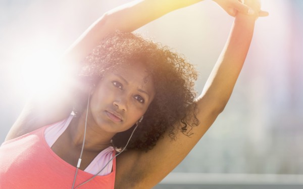 Mixed race woman stretching arms