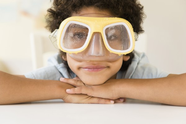 Mixed race boy wearing wet snorkel mask