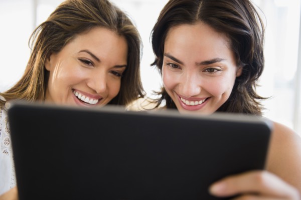 Hispanic women using digital tablet