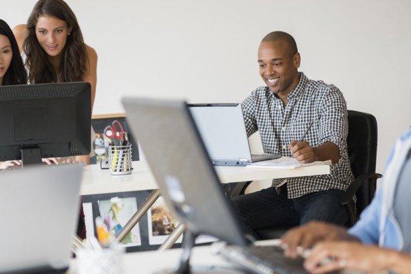Business people working together on computers in office