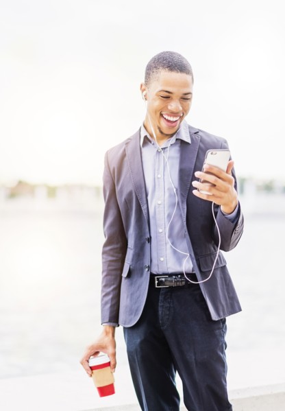 Black businessman using cell phone outdoors