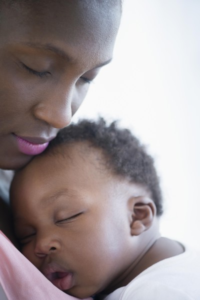 Close up of Black mother holding sleeping son