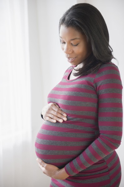 Black pregnant woman admiring her stomach
