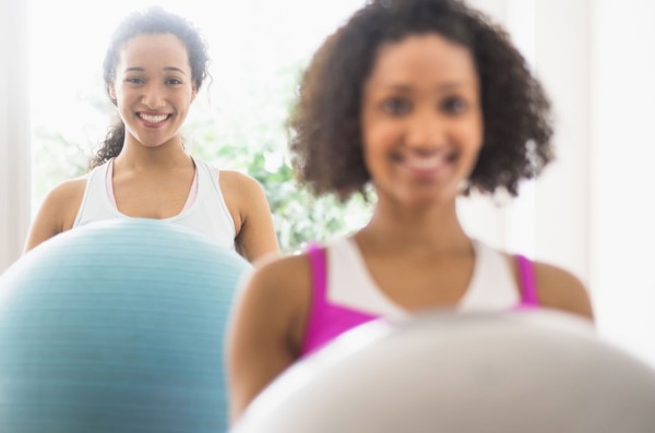 Women working out with fitness balls in exercise class