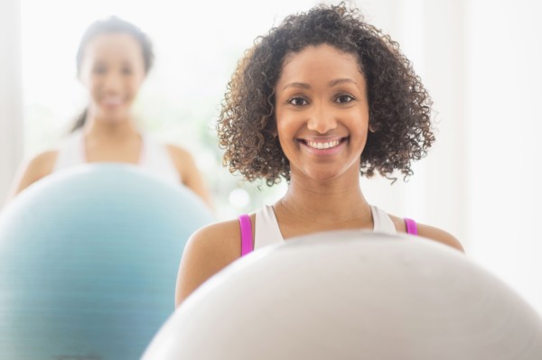 Women working out with fitness balls in exercise class