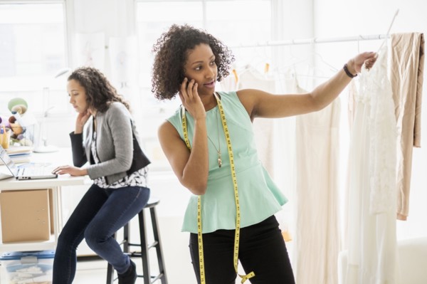 Dressmaker talking on cell phone in office