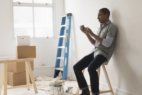 Black man sitting in room under renovation