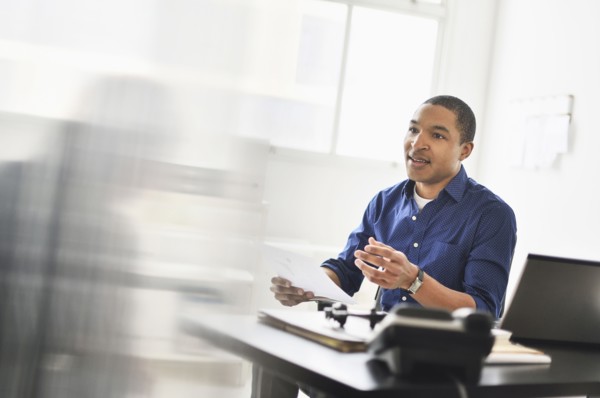 Black businessman talking at office desk
