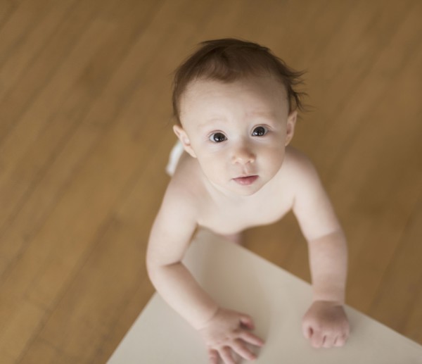 Caucasian baby looking up at table