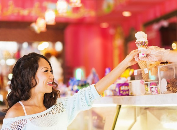 Chinese woman buying ice cream cone in shop