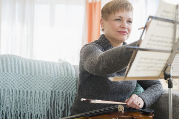 Caucasian violinist writing on sheet music