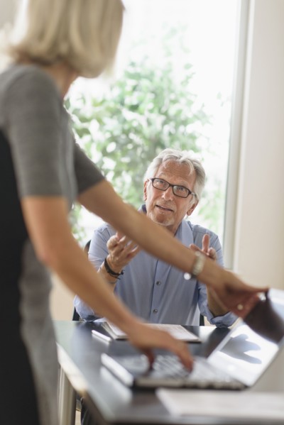 Older Caucasian business people arguing in office meeting