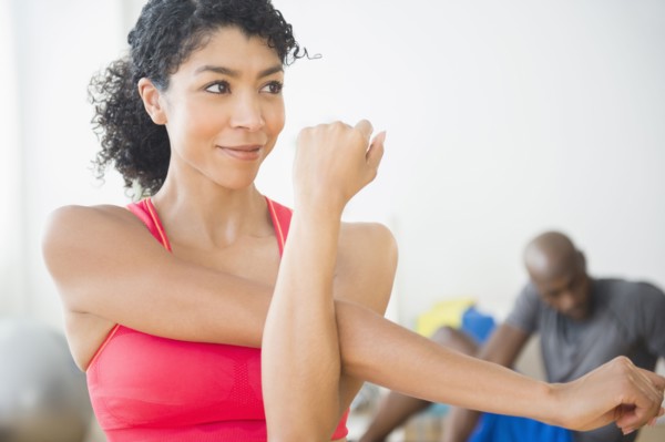 Close up of woman stretching in gym