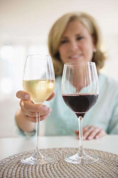 Caucasian woman choosing white wine and red wine