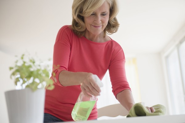 Caucasian woman cleaning table
