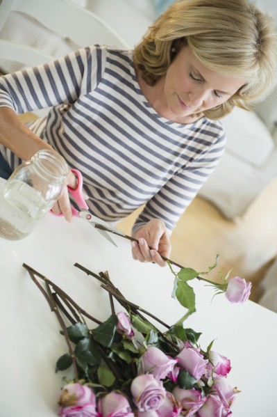 Caucasian woman trimming flowers