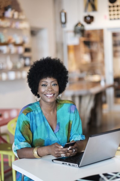 African American business owner using laptop in store
