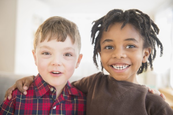 Close up of smiling boys hugging