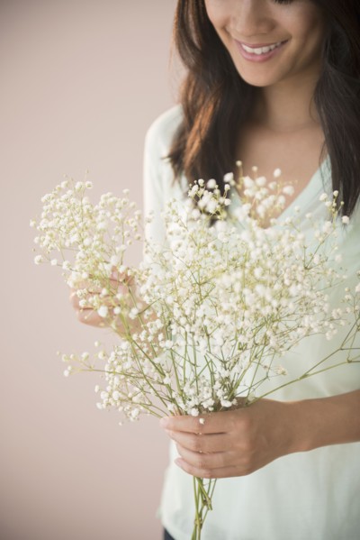 Chinese woman holding bunch of flowers