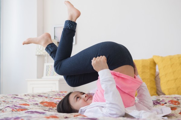 Girl playing on bed