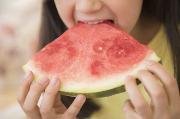 Close up of girl eating watermelon
