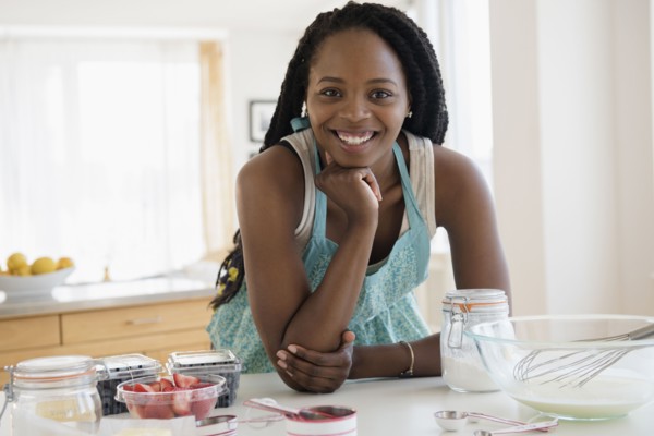 Black woman baking in kitchen