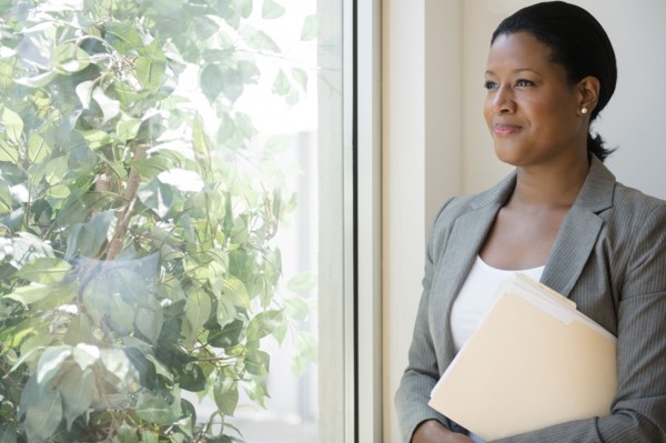Black businesswoman looking out window