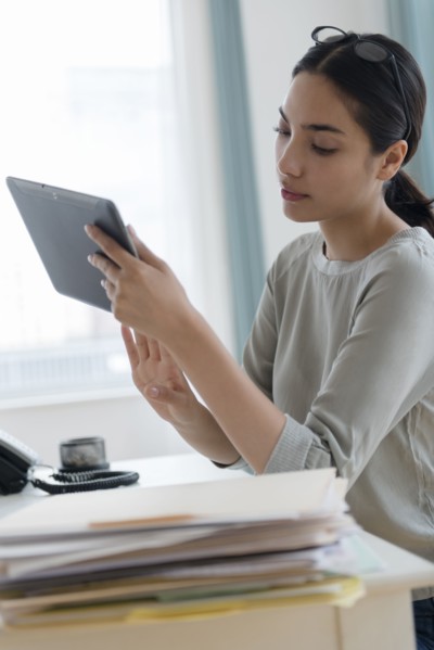 Hispanic businesswoman using digital tablet