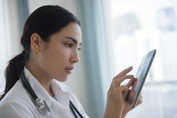 Hispanic doctor using digital tablet