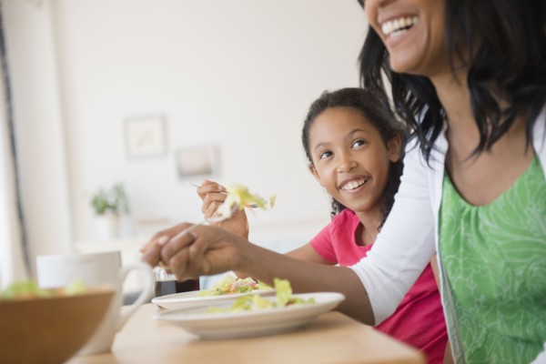 Mother and daughter eating salad