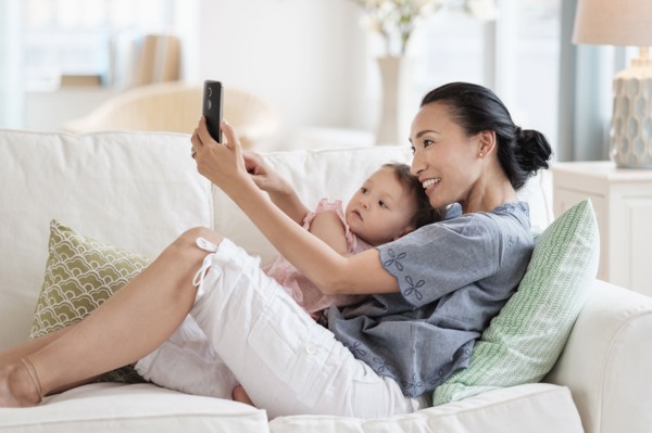 Mother taking selfie with baby daughter