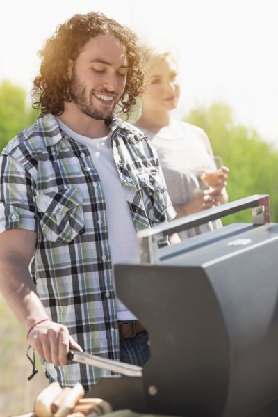 Caucasian man grilling at barbecue